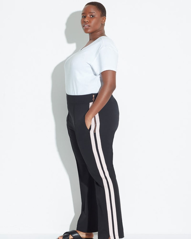 Side of a model wearing a size 14 The Tailored Track Pant in Classic Black by See Rose Go. | dia_product_style_image_id:257789